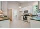 Kitchen featuring white cabinetry, stainless steel appliances, and an open design at 125 Chimney Rise Dr, Cary, NC 27511