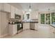 Kitchen with stainless appliances, white cabinetry and an abundance of natural light at 125 Chimney Rise Dr, Cary, NC 27511