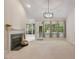 Bright living room with fireplace and large windows offering lots of natural light at 125 Chimney Rise Dr, Cary, NC 27511