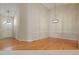 Open-concept living room with hardwood flooring, neutral paint, and an elegant light fixture at 125 Chimney Rise Dr, Cary, NC 27511