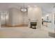 Spacious living room with fireplace open to kitchen offering hardwood flooring at 125 Chimney Rise Dr, Cary, NC 27511