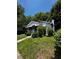Quaint single-story home surrounded by lush greenery and mature trees, offering a private setting at 1305 E Jones St, Raleigh, NC 27610