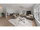 Open-concept living area with modern furnishings and stylish decor, open to dining area at 1400 Gathering Park Cir # 203, Cary, NC 27519