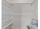 Walk-in closet with white shelving, clothing rods, and overhead lighting at 1400 Gathering Park Cir # 301, Cary, NC 27519