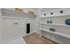 Bright laundry area with shelves, hanging rod, hook-ups and vinyl flooring at 1400 Gathering Park Cir # 301, Cary, NC 27519