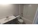 Modern bathroom with a combination tub and shower, plus a gray vanity with a white countertop at 147 River Chapel Dr, Fuquay Varina, NC 27526