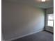 A quiet, carpeted bedroom features neutral walls and a bright window at 147 River Chapel Dr, Fuquay Varina, NC 27526