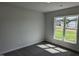Well-lit bedroom with neutral walls, plush carpeting and a large window at 147 River Chapel Dr, Fuquay Varina, NC 27526