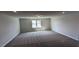 Large bonus room with neutral walls, carpet flooring, and a window for natural light at 147 River Chapel Dr, Fuquay Varina, NC 27526
