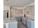 Bright kitchen featuring gray cabinetry, an island with a sink, and modern finishes at 147 River Chapel Dr, Fuquay Varina, NC 27526
