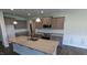 Kitchen with stainless steel appliances, granite countertops, and gray cabinets at 147 River Chapel Dr, Fuquay Varina, NC 27526