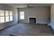 Spacious living room with a fireplace, large windows and pre-installed wiring for entertainment at 147 River Chapel Dr, Fuquay Varina, NC 27526
