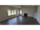 Bright living room featuring a fireplace, several windows, and dark wood flooring at 147 River Chapel Dr, Fuquay Varina, NC 27526