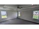 Spacious main bedroom with tray ceiling, carpet, and multiple windows at 147 River Chapel Dr, Fuquay Varina, NC 27526
