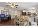 Open-concept living area featuring hardwood floors, a dining table, kitchen, and sleek entertainment center at 1508 Carroll Heights Rd, Zebulon, NC 27597