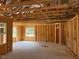 Unfinished room featuring exposed framing, windows, and wiring in a new construction home at 171 Surles Landing Way, Benson, NC 27504