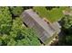 Aerial view of home showing the roof and surrounding yard with mature trees providing ample shade at 18 Red Pine Rd, Chapel Hill, NC 27516