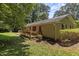 Backyard view with deck and mature trees at 18 Red Pine Rd, Chapel Hill, NC 27516