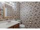 Traditional half bath features floral wallpaper, decorative mirror, and white sink at 18 Red Pine Rd, Chapel Hill, NC 27516