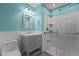 Modern bathroom with a gray vanity, white tile shower, and blue walls at 18 Red Pine Rd, Chapel Hill, NC 27516