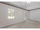 Bedroom featuring neutral carpet, a ceiling fan, exterior door, closet and floral wallpaper border at 18 Red Pine Rd, Chapel Hill, NC 27516