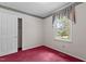 Bedroom with an open closet door, window, red carpet, and floral wallpaper border at 18 Red Pine Rd, Chapel Hill, NC 27516
