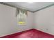 Simple bedroom with a window, red carpet, and floral wallpaper border at 18 Red Pine Rd, Chapel Hill, NC 27516