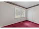Bedroom featuring red carpet, closet doors and a large window with floral wallpaper border at 18 Red Pine Rd, Chapel Hill, NC 27516