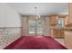 Traditional dining area with chandelier, glass door, vintage wallpaper, and direct access to kitchen with light wood cabinets at 18 Red Pine Rd, Chapel Hill, NC 27516