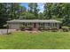 Charming single-story home featuring a brick pathway, well-manicured lawn, and an inviting red front door at 18 Red Pine Rd, Chapel Hill, NC 27516