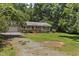 This single-story home boasts a well-maintained lawn, a brick pathway, and an inviting exterior at 18 Red Pine Rd, Chapel Hill, NC 27516