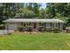 Front exterior view of home with brick walkway, well-maintained lawn, and an attached one-car garage at 18 Red Pine Rd, Chapel Hill, NC 27516