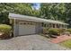 This charming home features an attached garage and manicured landscaping, enhancing its curb appeal at 18 Red Pine Rd, Chapel Hill, NC 27516