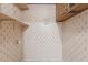 A classic laundry room featuring pineapple wallpaper, shelving, and basic utilities for easy wash and dry at 18 Red Pine Rd, Chapel Hill, NC 27516