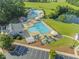 Aerial view of a community pool, a lake, and a clubhouse at 208 Holly Green Ln, Holly Springs, NC 27540