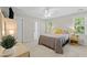 Cozy bedroom filled with natural light features a ceiling fan and two bright windows at 208 Holly Green Ln, Holly Springs, NC 27540