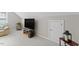 A well-lit bonus room with a TV, storage, and neutral carpeting at 208 Holly Green Ln, Holly Springs, NC 27540