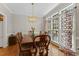A view of the dining table next to windows with decorative curtains and natural light at 208 Holly Green Ln, Holly Springs, NC 27540