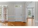 A bright entryway with hardwood floors, leading to adjacent rooms at 208 Holly Green Ln, Holly Springs, NC 27540