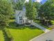 Charming two-story home with manicured lawn, mature trees, and an inviting curb appeal at 208 Holly Green Ln, Holly Springs, NC 27540