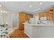 Bright kitchen features wood cabinets, white appliances, and a breakfast bar for casual dining at 208 Holly Green Ln, Holly Springs, NC 27540