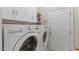 Laundry room featuring a washer and dryer and white shelving at 208 Holly Green Ln, Holly Springs, NC 27540