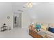 Spacious living room features a ceiling fan, comfortable sofa, and bright natural light at 208 Holly Green Ln, Holly Springs, NC 27540