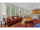 Spacious living area with hardwood floors next to breakfast nook with tons of natural light at 208 Holly Green Ln, Holly Springs, NC 27540