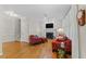 Cozy living room with fireplace, hardwood floors, and comfortable seating at 208 Holly Green Ln, Holly Springs, NC 27540