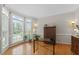 Bright office space featuring hardwood floors and natural light from many windows at 208 Holly Green Ln, Holly Springs, NC 27540