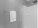 Gray tiled walk in shower with white shower head and new shower door at 208 Holly Green Ln, Holly Springs, NC 27540