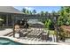 Relaxing backyard patio with stone fire pit and comfortable seating under a charming pergola, perfect for outdoor living at 2112 Colin Hill Ct, Wake Forest, NC 27587