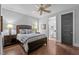 Comfortable bedroom with wood floors, a ceiling fan, and ensuite bath access at 2112 Colin Hill Ct, Wake Forest, NC 27587