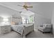 Serene bedroom with a ceiling fan, neutral color palette, and a cozy sitting area by the window at 2112 Colin Hill Ct, Wake Forest, NC 27587